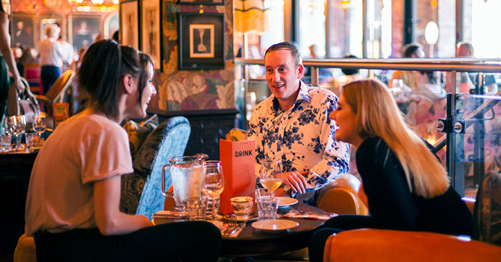 group of friends drinking and laughing inside the Cosy Club, Durham